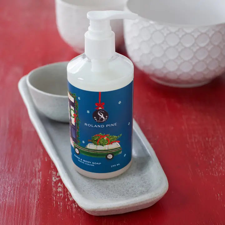 Soap & Paper Factory Roland Pine holiday hand and body wash in pump bottle on a decorative tray