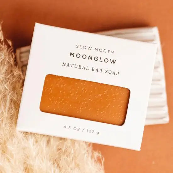 Slow North Moonglow natural bar soap in a white box on a textured surface