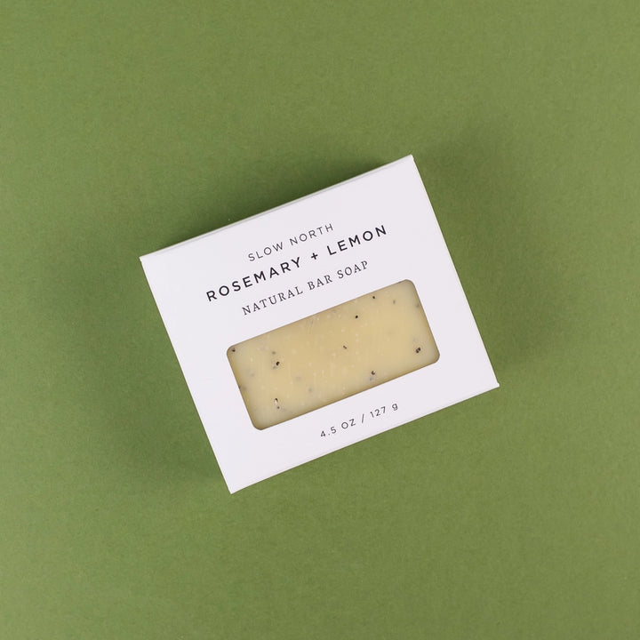 Slow North rosemary lemon bar soap in a white box with natural ingredients and a clear window