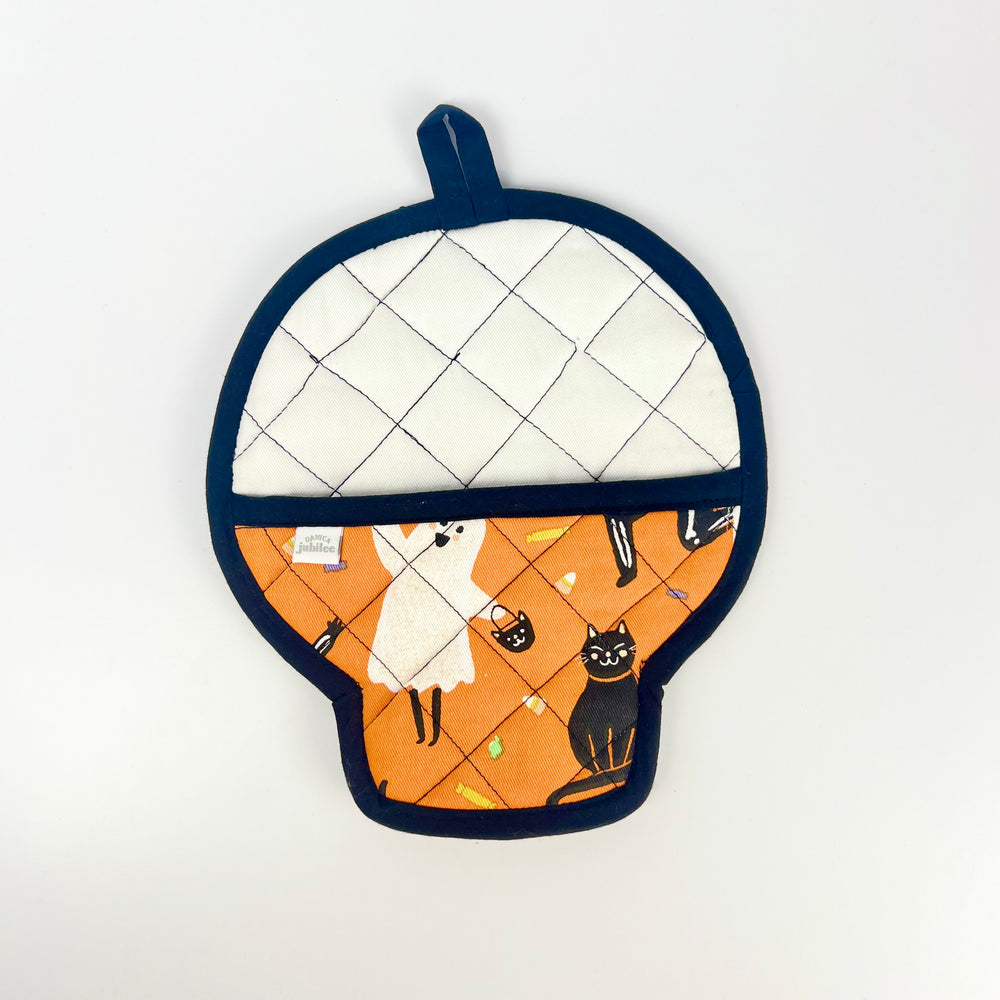 Danica skull pot holder shaped like a skull with orange ghost and black cat print white quilted back