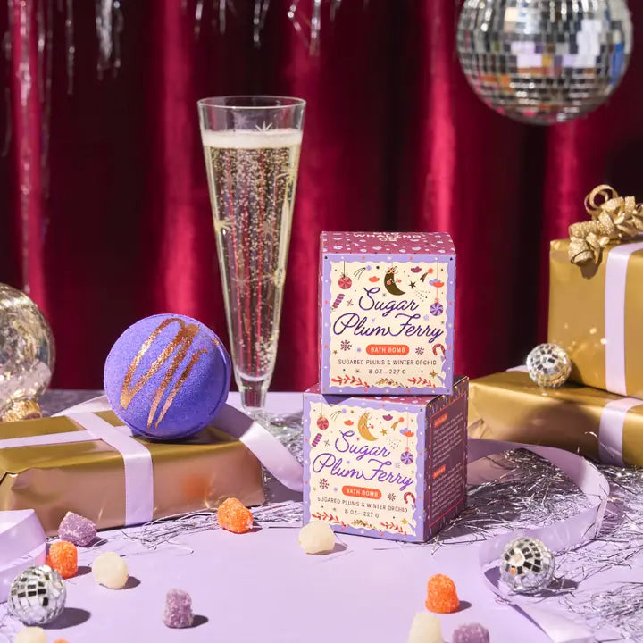 Sugar Plum Bath Bomb by Old Whaling Co on a festive table with decorations and drinks