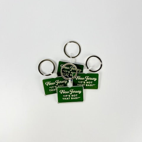 Acme New Jersey keychain with green rectangular tag and white text saying Its not that bad