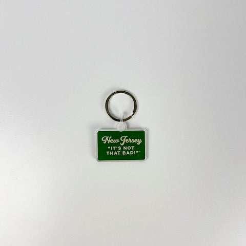 Acme New Jersey keychain with green rectangular tag and white text saying Its Not That Bad