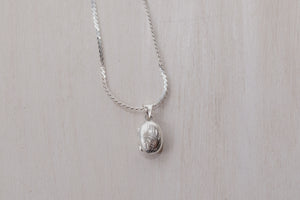 up closed photo of the oval shaped locket