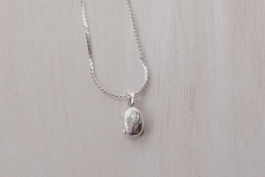 up closed photo of the oval shaped locket