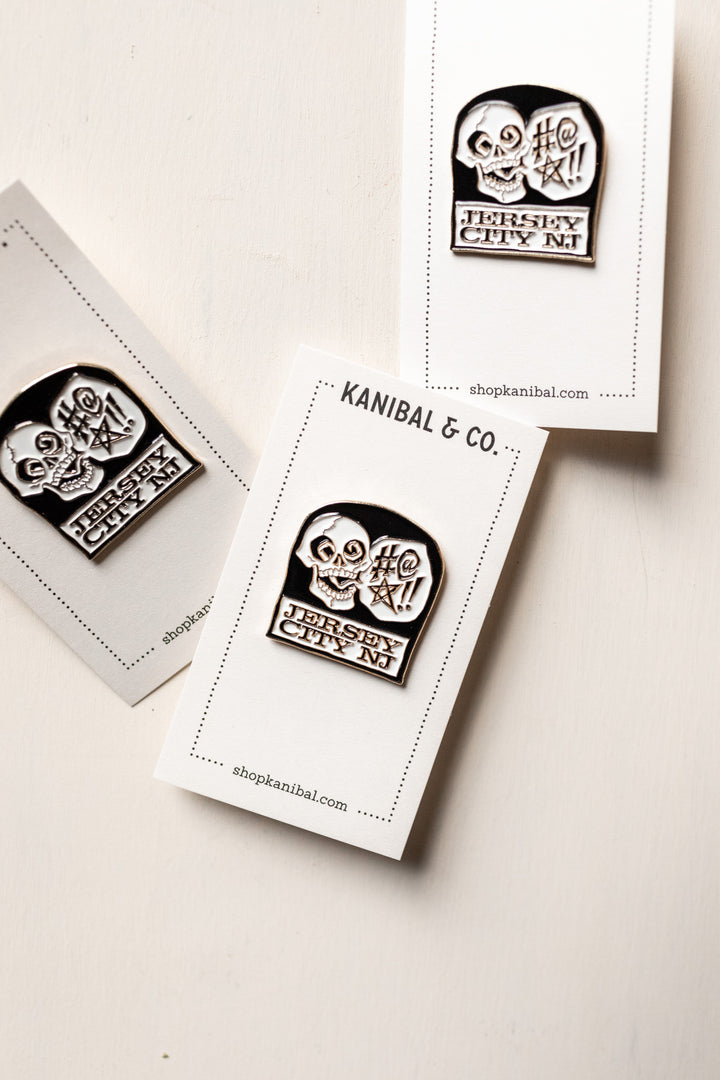 3 black and white pins with skull on headstone on cardstock