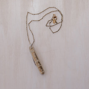  A Masonic knife pendant paired with an antique brass chain