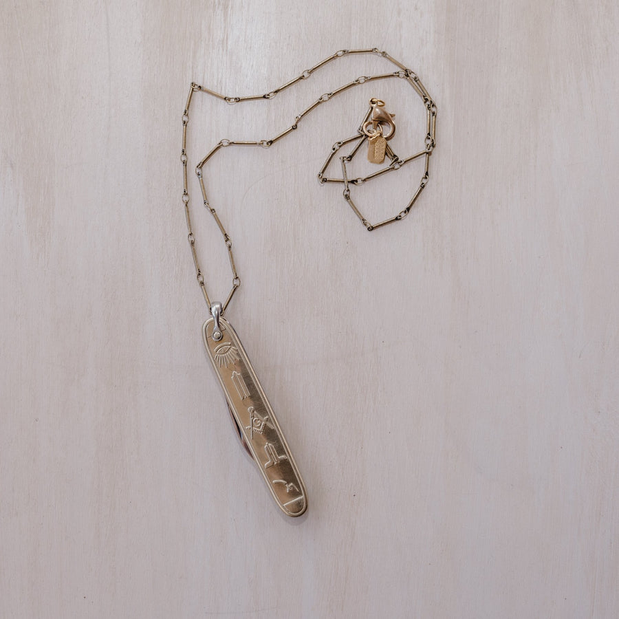  A Masonic knife pendant paired with an antique brass chain