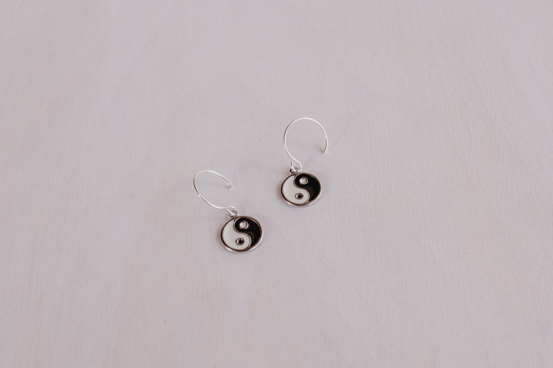 2 earrings with black and white ying yangs