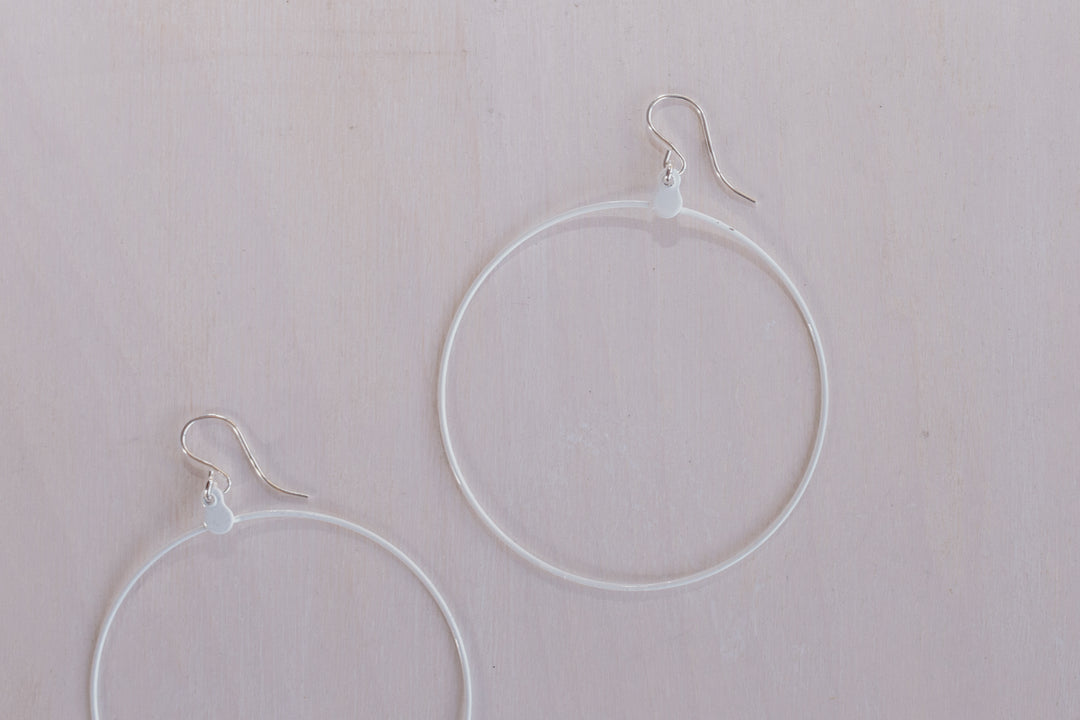 close up shot of 2 white hoop earring