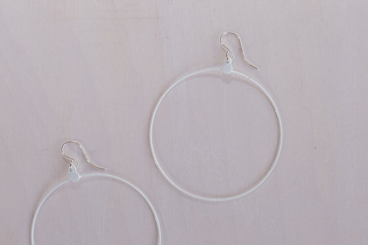 close up shot of 2 white hoop earring