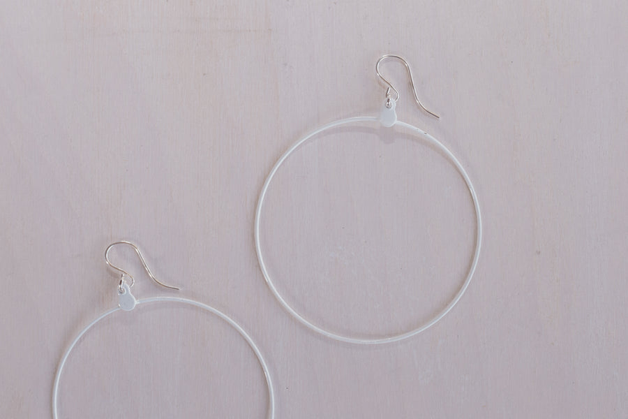 close up shot of 2 white hoop earring