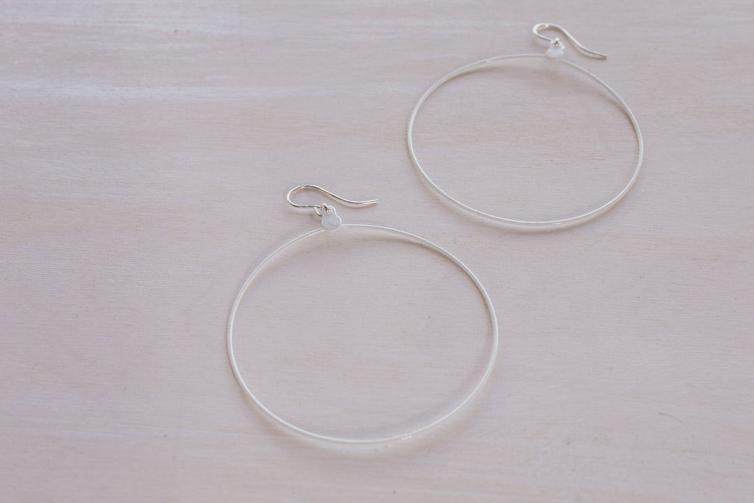 2 white hoop earrings
