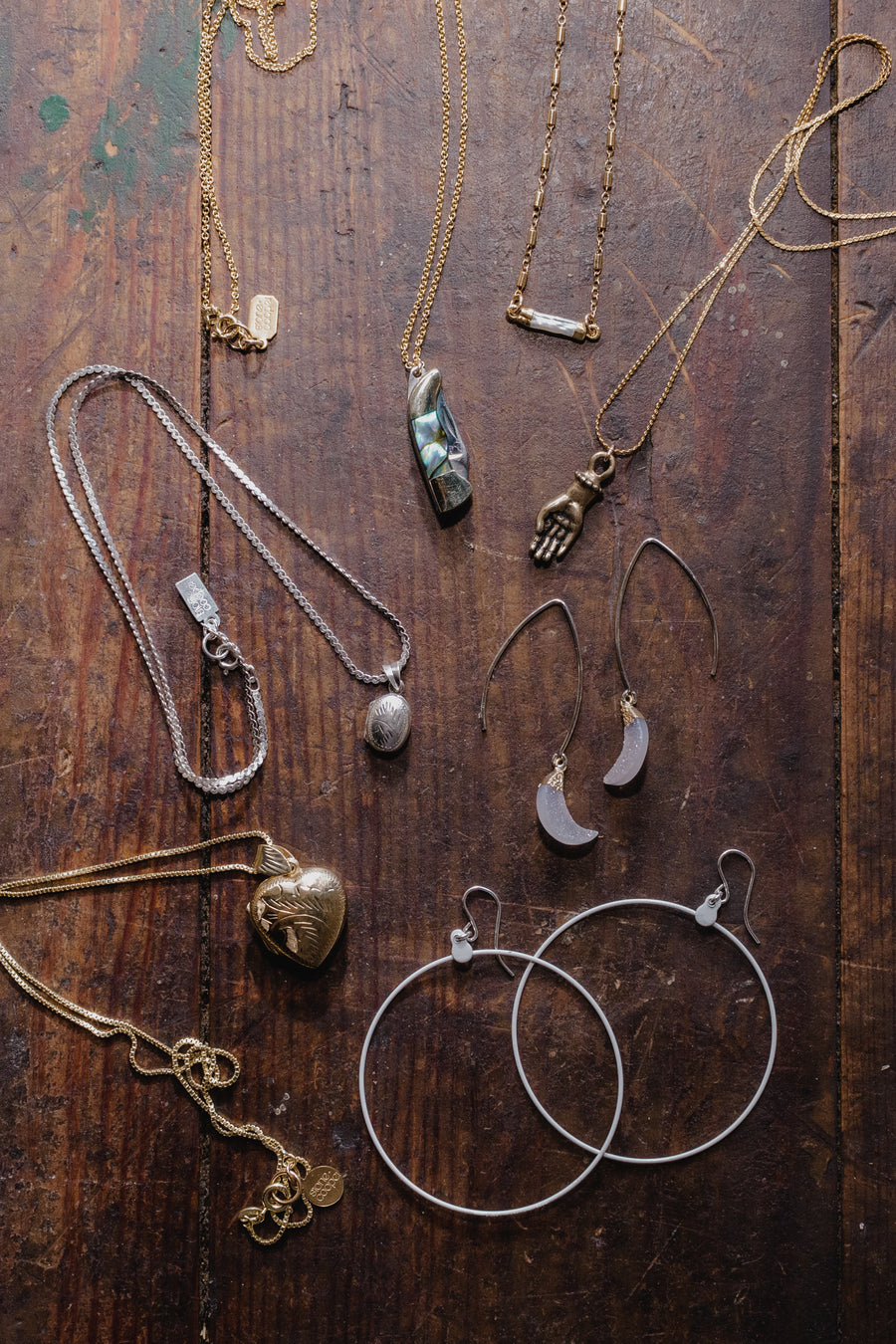 table with multiple necklaces and earrings on it