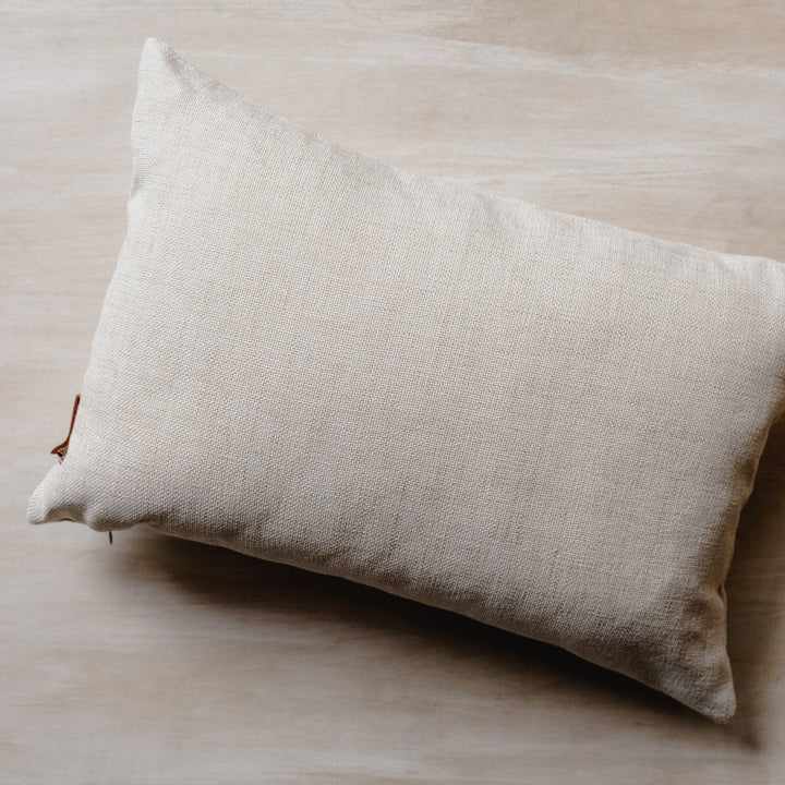 back of cream pillow
