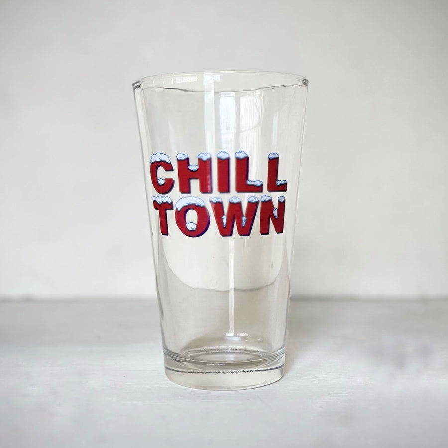 Pint glass with red lettering and snow on the letters, reads "Chill Town"
