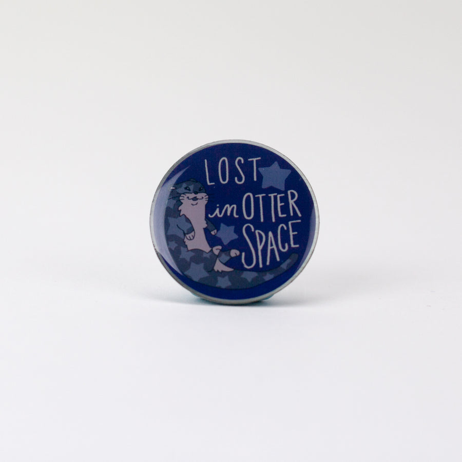 blue round pin with illustration of otter