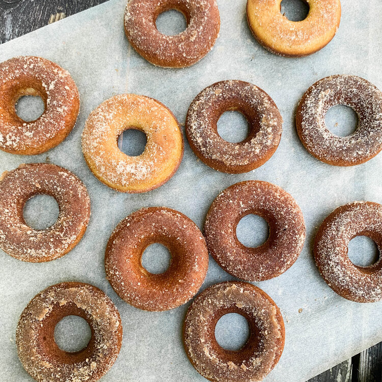 Freshly baked doughnuts sprinkled with sugar from the apple cider doughnut baking kit