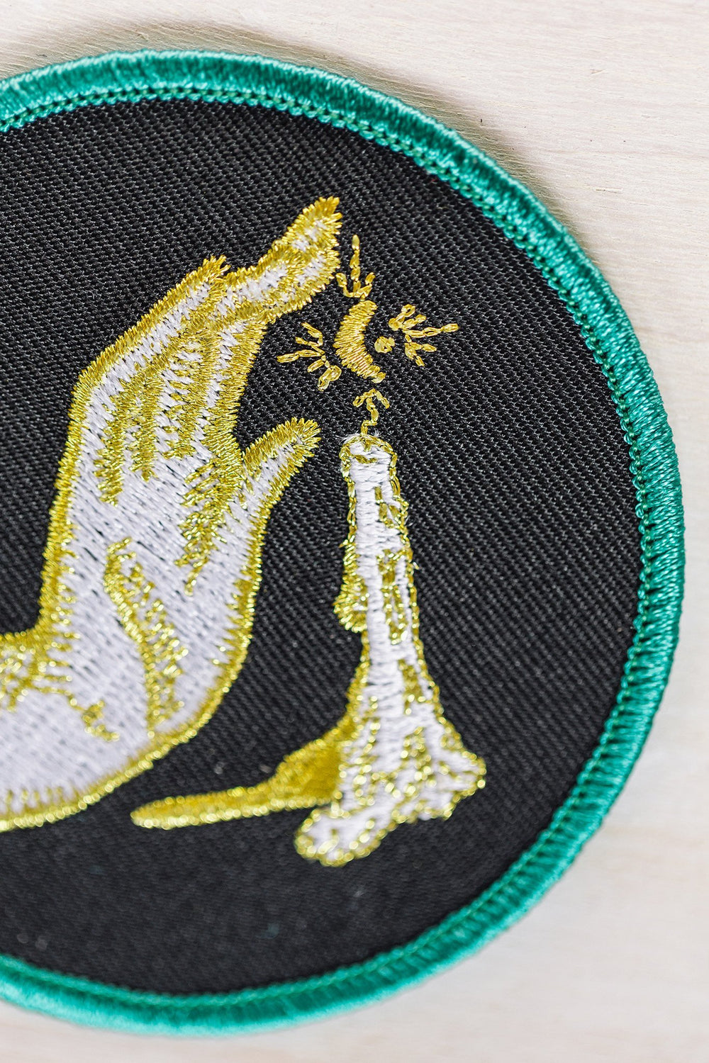 Kanibal & Co candlelight embroidered patch with hand and candle design on black fabric