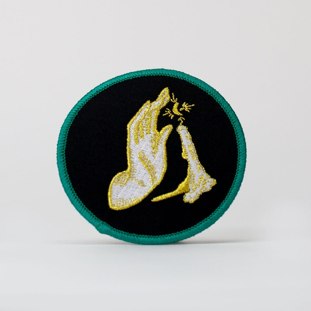 Kanibal & Co candlelight embroidered patch with hand and candle design on black background