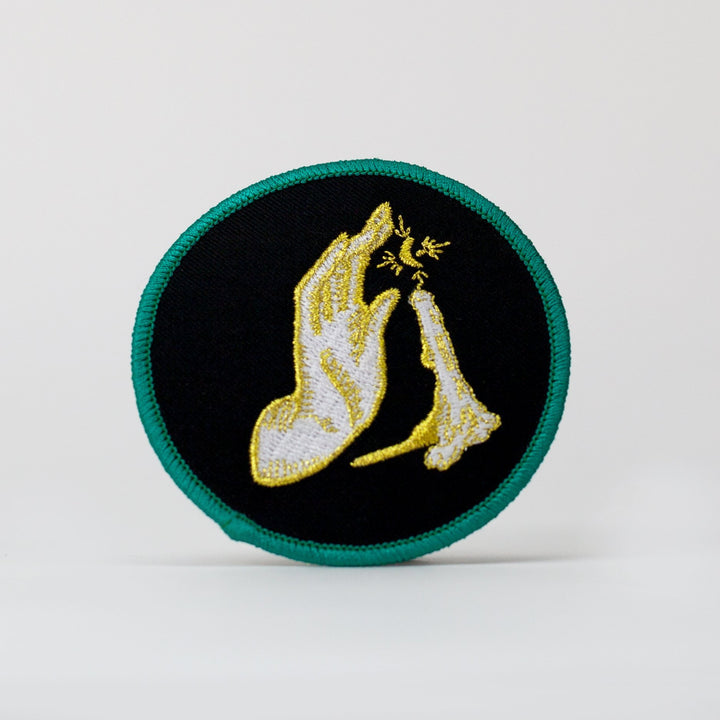 Kanibal & Co candlelight embroidered patch with hand and candle design on black background