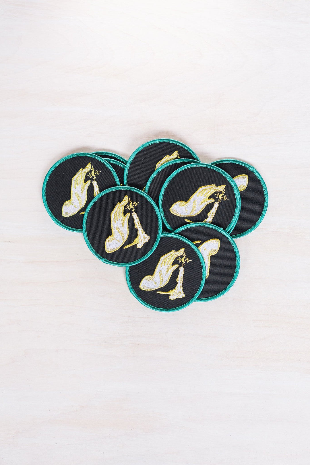 Kanibal & Co candlelight embroidered patch with hand holding a lit candle on black fabric