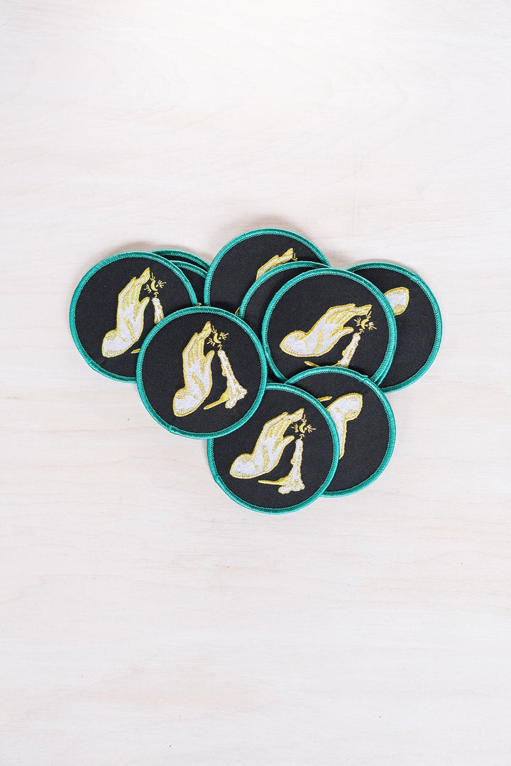 Kanibal & Co candlelight embroidered patch with hand holding a lit candle on black fabric