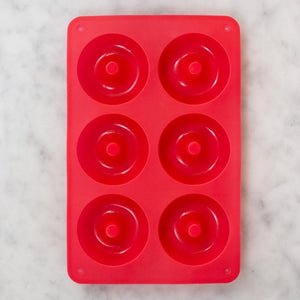 Red rectangular silicon baking tray with 6 round holes for donut mix