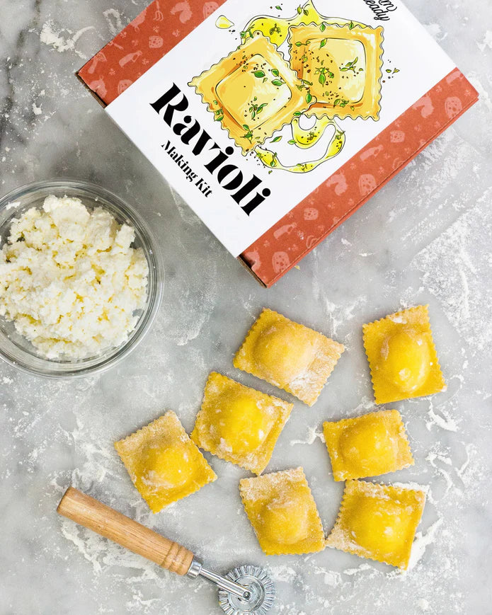 DIY ravioli making kit by Farm Steady Brooklyn Brew Shop with fresh ravioli, cheese, and pasta cutter on marble surface