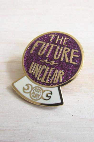 purple and white crystal ball pin on table