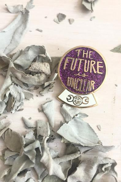 purple and white crystal ball in on table with scraps around it