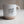 Kanibal Co. Jersey City ceramic mug with speckled white upper and beige bottom with script text