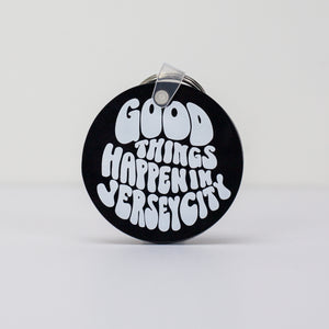 Kanibal & Co. black round Jersey City souvenir keychain with white Good Things Happen In Jersey City text