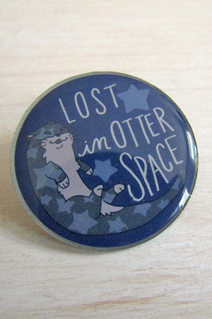 Kanibal & Co otter space enamel pin with cartoon otter and text lost in otter space on dark blue background