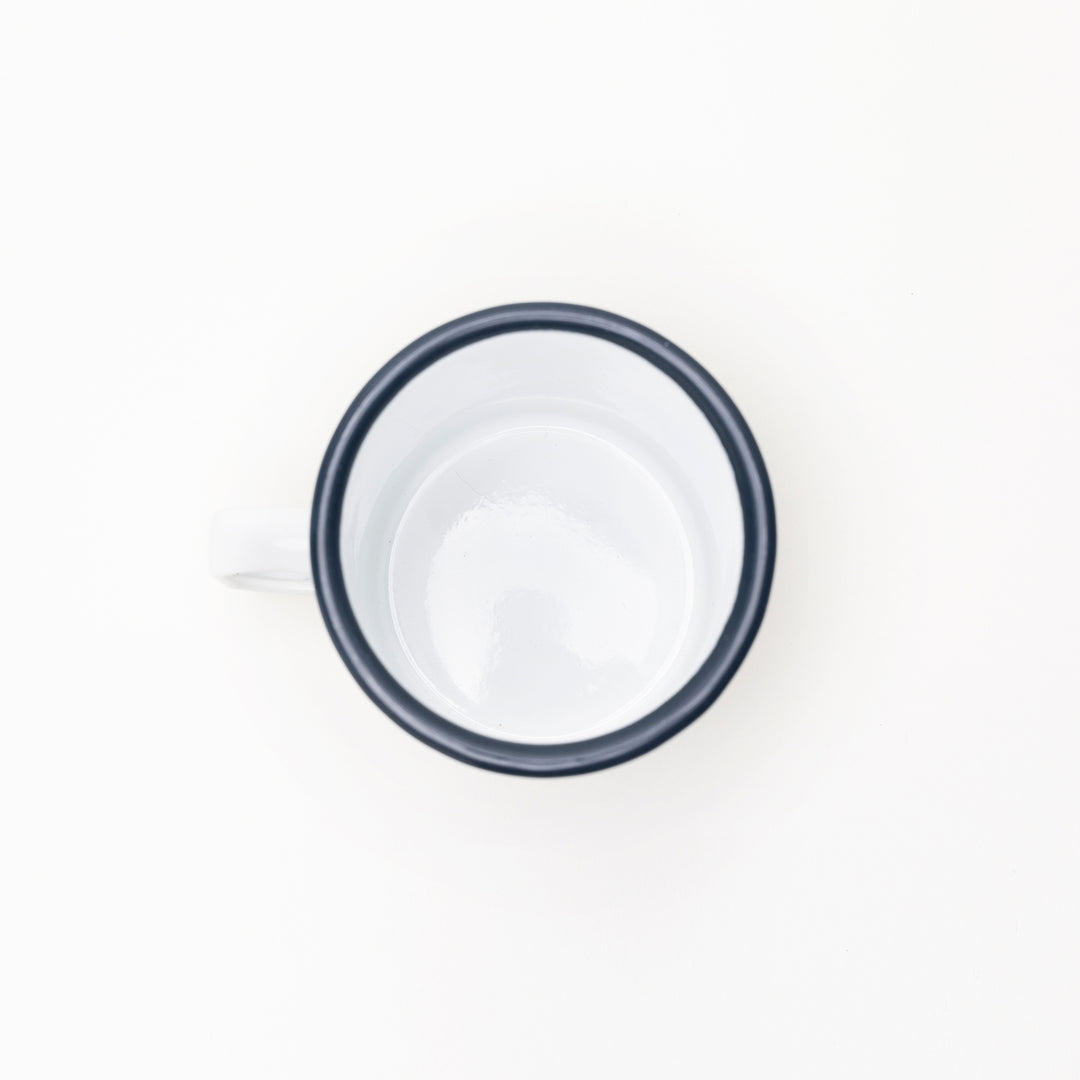 Top view of a white jackalope enamel mug with a black rim by Kanibal & Co