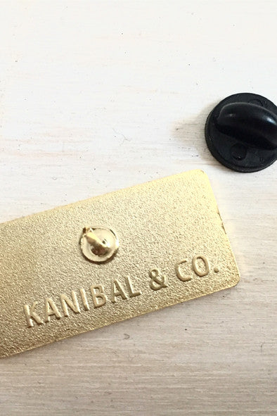 gold back of pin with black pin backing