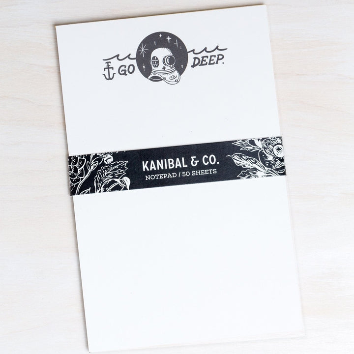 rectangular notepad with black and white illustration of scuba diver