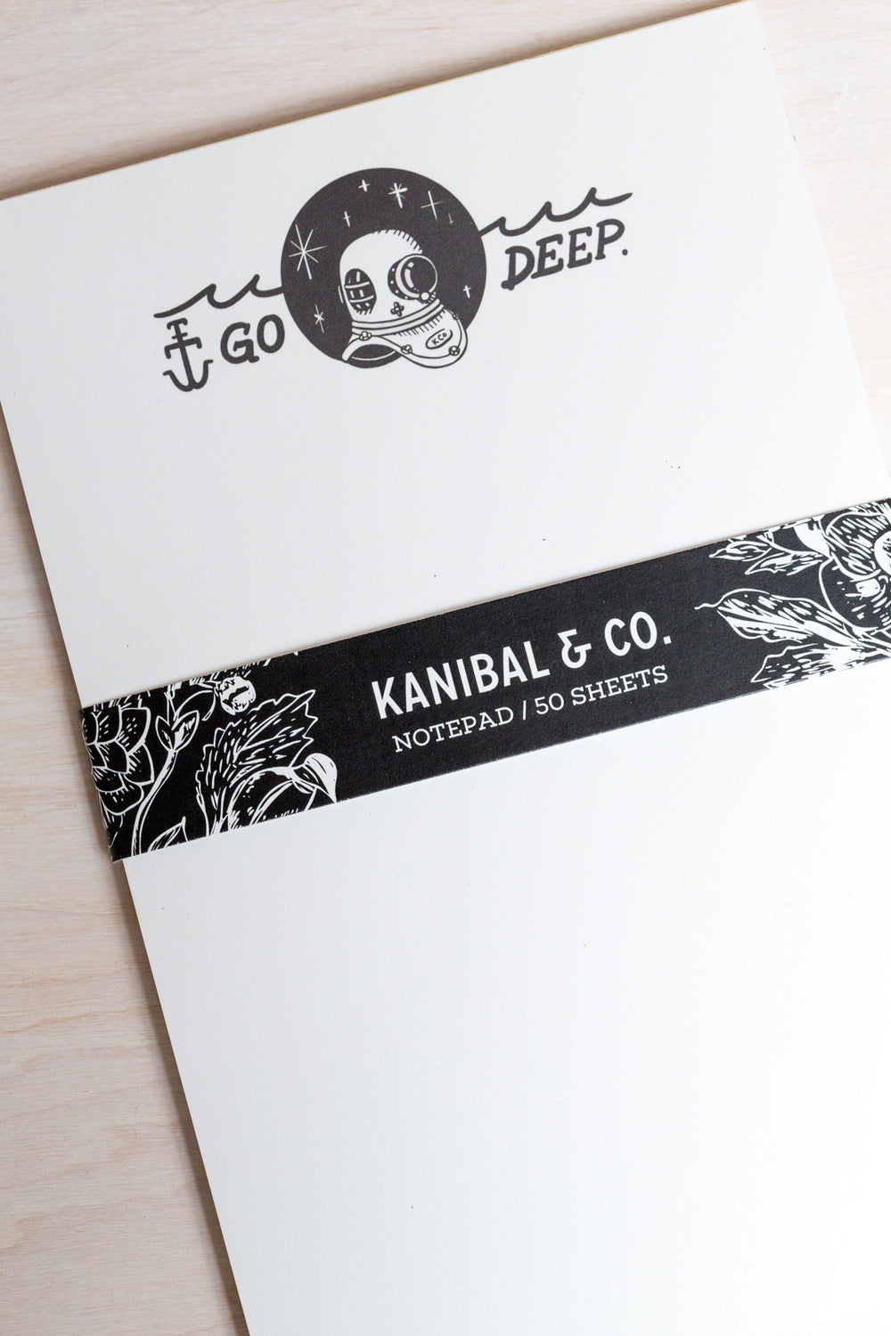 rectangular notepad with black and white illustration of scuba diver