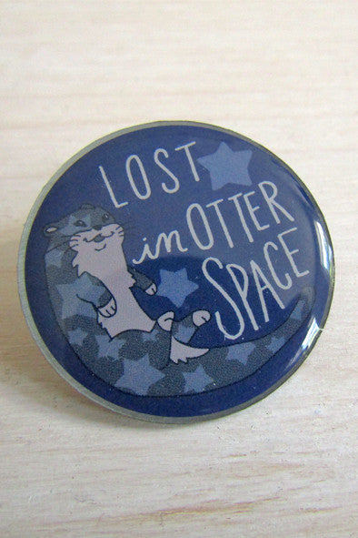 blue round pin with illustration of otter