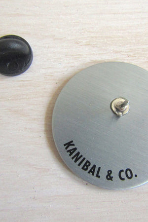 gold back of pin with black pin backing