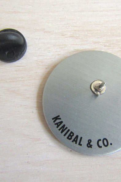 gold back of pin with black pin backing
