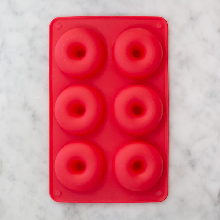 Red silicone doughnut pan with six molds for easy non-stick baking by Farm Steady Brooklyn Brew Shop